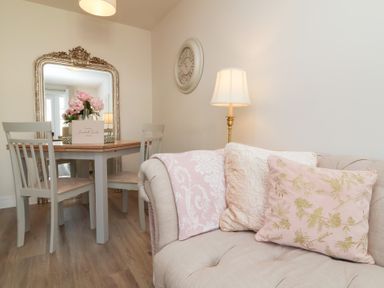 A dining room with a table and chairs at Seashell Sands in Appledore