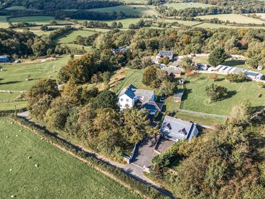 An aerial view of a property with fields and trees at The Manor House Skerry Vore Bryn Pydew near Llandudno Junction