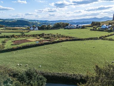 A landscape with sheep grazing in fields at The Manor House Skerry Vore in Bryn Pydew near Llandudno Junction