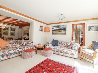 A living room with sofas and a coffee table at Temple House in Goonhavern