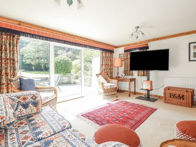 A snug with seating area and television at Temple House in Goonhavern
