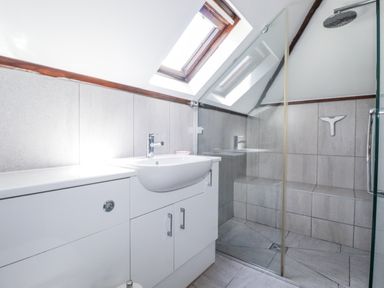 A bathroom with a shower and sink at Temple House in Goonhavern