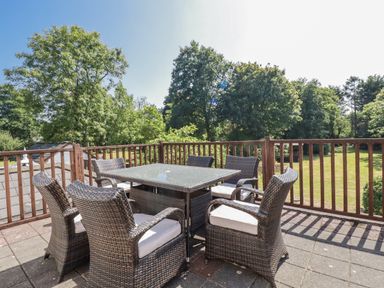 A patio with a table and chairs at Temple House in Goonhavern