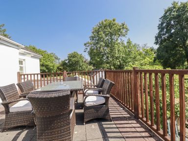 A patio with a table and chairs at Temple House in Goonhavern