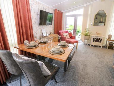 A dining room with a table set for a meal at Plot 32 High Hesket near Armathwaite