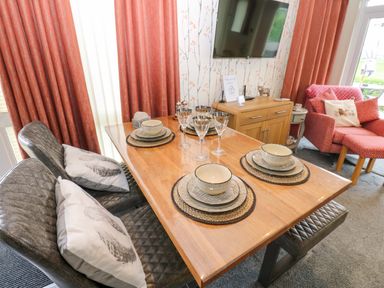A dining room with a table set for meals at Plot 32 High Hesket near Armathwaite