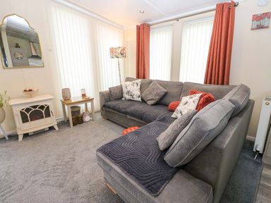 A living room with a sofa and coffee table at Plot 32 in High Hesket near Armathwaite