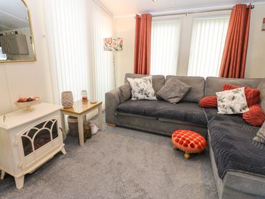 A living room with a sofa and decorative items at Plot 32 High Hesket near Armathwaite
