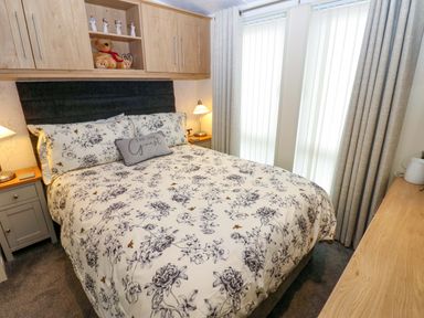 A bedroom with a bed and bedside table at Plot 32 High Hesket near Armathwaite