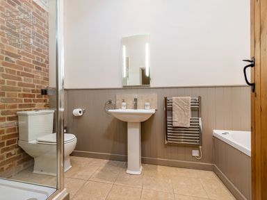 A bathroom with a toilet shower sink and bathtub at Pheasant in Wheatacre
