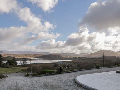 A landscape with hills a lake and a gravel driveway at Moorhen House in Loughanure near Annagry County Donegal