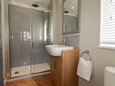 A bathroom with a shower enclosure a sink with cabinet and a towel ring at 23 Meadow Retreat Dobwalls