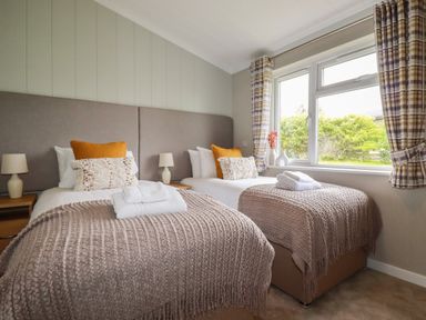 A bedroom with two single beds side by side with knitted blankets and pillows at 6 Faraway Fields in Dobwalls
