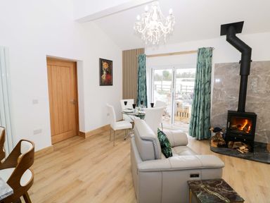 A living room with furniture and a fireplace at The Barn in Astwood Bank