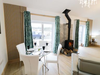 A dining room with a table and chairs at The Barn in Astwood Bank