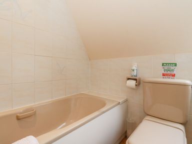 A bathroom with a bathtub and a toilet at Lodge 2 - Inglewood Lodge in Spean Bridge