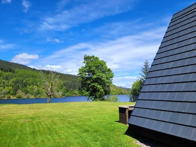 A view of a lake with trees and mountains at Lodge 2 - Inglewood Lodge Spean Bridge