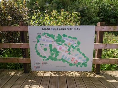 A site map of Manleigh Park showing chalets log cabins lodges caravans bungalow laundry reception and fire points at 18 Manleigh Park in Combe Martin