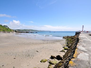A beach with people at Sea Pinks in Looe