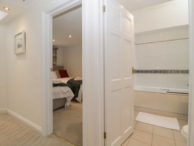 A hallway showing a bedroom with a bed and a bathroom with a bathtub at 4 Barton Cottages Down Thomas near Plymouth