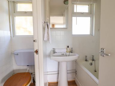 A bathroom with a toilet a sink and a bathtub at Hill View in Bryncrug near Tywyn