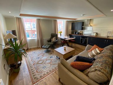 A combined living room and kitchen with a sofa and coffee table at Picadore Two in Scarborough