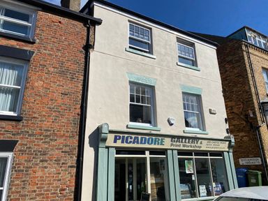 A three-story building with windows and a sign for Picadore Gallery and Print Workshop at Picadore Two in Scarborough