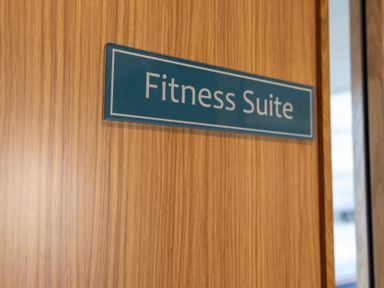 A door with a sign indicating Fitness Suite at Lodge 66 at Riviera Bay Coastal Retreat Brixham