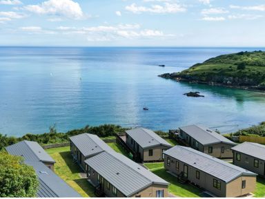 Outdoor area with cabins overlooking the sea at Lodge 74 at Riviera Bay Coastal Retreat Brixham