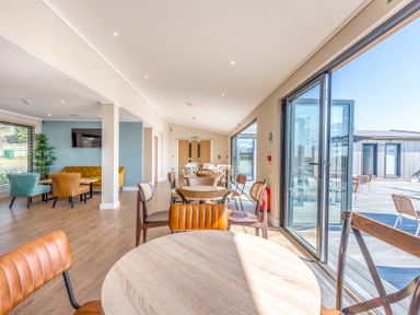 A dining room with tables and chairs at Lodge 74 at Riviera Bay Coastal Retreat Brixham