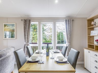 A dining room with a table set for meal at Lodge 55 at Riviera Bay Coastal Retreat Brixham