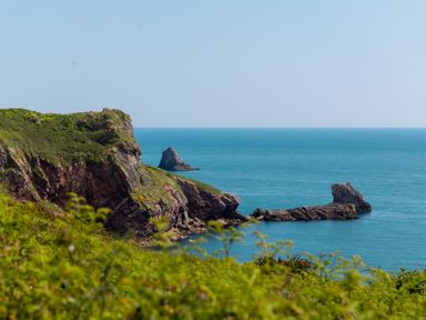 A coastal view with cliffs and rock formations at Lodge 68 at Riviera Bay Coastal Retreat Brixham