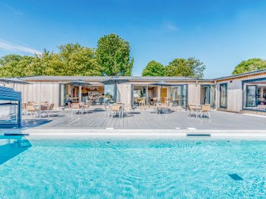 An outdoor area with a swimming pool and deck chairs at Lodge 68 at Riviera Bay Coastal Retreat Brixham