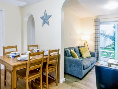 A dining room with a table and chairs at Chalet 34 at Landscove Holiday Park in Brixham