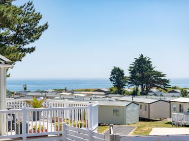 An outdoor area with mobile homes and ocean view at Chalet 38 at Landscove Holiday Park Brixham