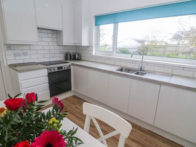 A kitchen with cabinets and sink at Bod A Quinte in Carbis Bay