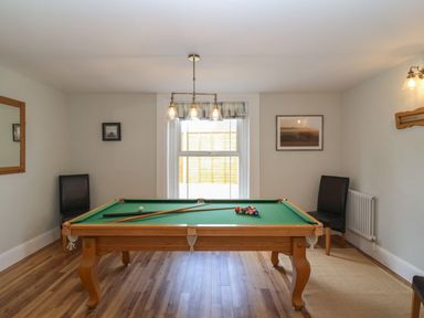 A game room with a pool table and two chairs at Metcalfe House in Compton Dundon