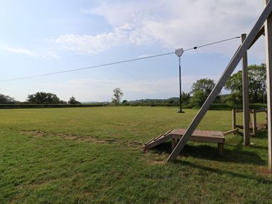 An outdoor area with a zip line and play structure at Metcalfe House in Compton Dundon