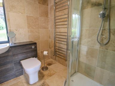 A bathroom with a toilet sink shower and heated towel rail at Timberdyne in Brimfield near Woofferton