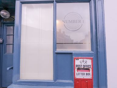 A blue door and window with a red post office letter box attached to the wall at Number 1 in Clare