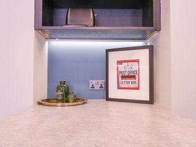 A countertop with decorative jars on a tray and a framed post office letter box sign at Number 1 in Clare