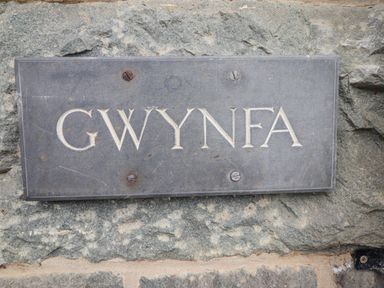 A stone plaque with the word Gwynfa mounted on a stone wall at Gwynfa in Barmouth