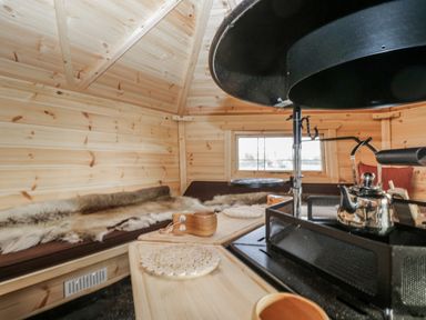 An indoor space with wooden walls, a sofa, and a kettle at 1 Gilpin House Levens