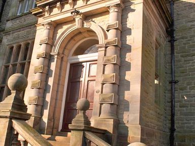 Stone entrance with stairs and double wooden doors at The Hall in Belford