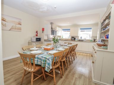 A dining area with a table set for dinner at Beach House in Winterton-On-Sea