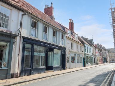A street view with shops and old buildings along a road at The Old Factory House in Berwick-Upon-Tweed