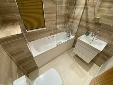 A bathroom with a bathtub a sink and a toilet at Lodge 18 - The Pines in Runswick Bay