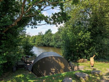 An outdoor area with a tent near a river at Silver Birch in Dolton