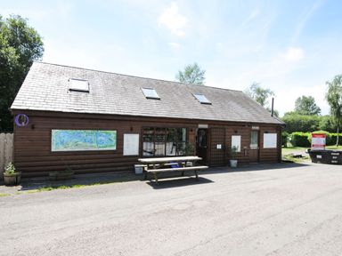 A building with a map outside and a picnic table at Silver Birch in Dolton