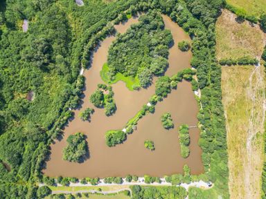An aerial view of a water body surrounded by trees and greenery at Silver Birch in Dolton